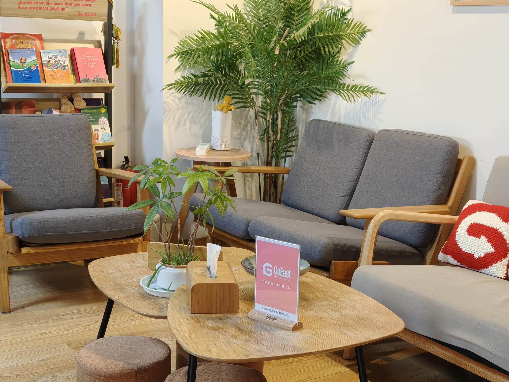Grey seating, books and plants in the GoEast Xuhui campus lounge